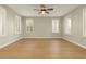 This is a spacious bedroom with light hardwood floors and window shutters with a ceiling fan at 9301 E Desert Arroyos --, Scottsdale, AZ 85255