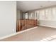 Second floor hallway with wood banister, carpet, and plantation shutters at 9301 E Desert Arroyos --, Scottsdale, AZ 85255