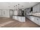 An open kitchen showcases gray cabinets, granite countertops, and stylish pendant lighting at 9301 E Desert Arroyos --, Scottsdale, AZ 85255