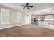 Open concept living room area with modern ceiling fan, shuttered windows, and grey paint at 9301 E Desert Arroyos --, Scottsdale, AZ 85255