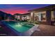 Beautiful backyard with a pool, patio, and lush desert landscaping at sunset at 13778 E Charter Oak Dr, Scottsdale, AZ 85259