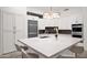 Modern kitchen with white cabinetry, stainless steel appliances, and a large island at 13778 E Charter Oak Dr, Scottsdale, AZ 85259