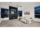 Bright living room with fireplace, neutral decor, and large windows overlooking the outdoors at 13778 E Charter Oak Dr, Scottsdale, AZ 85259
