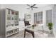 Bright home office with hardwood floors, a modern desk and custom shelving at 13778 E Charter Oak Dr, Scottsdale, AZ 85259