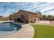 Home's backyard features a pool, patio, and grassy area at 18206 W Sells Dr, Goodyear, AZ 85395