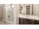 Bathroom with shower/tub combo and dark vanity at 18206 W Sells Dr, Goodyear, AZ 85395