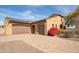 House exterior with solar panels, double garage, and landscaping at 18206 W Sells Dr, Goodyear, AZ 85395