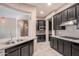 Modern kitchen with dark cabinets, granite counters, and stainless steel appliances at 18206 W Sells Dr, Goodyear, AZ 85395