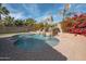 Inviting kidney shaped pool with a water feature and brick patio at 18206 W Sells Dr, Goodyear, AZ 85395