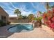 Inviting backyard pool with a stone fountain and lush landscaping at 18206 W Sells Dr, Goodyear, AZ 85395