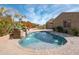 Inviting kidney-shaped pool with stone fountain and brick patio at 18206 W Sells Dr, Goodyear, AZ 85395