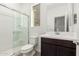 Clean bathroom with walk-in shower and dark vanity at 18428 W Poston Dr, Surprise, AZ 85387