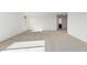 Bright bedroom with carpeted floor and access to bathroom at 18428 W Poston Dr, Surprise, AZ 85387