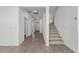 Spacious hallway with wood-look tile flooring and staircase at 18428 W Poston Dr, Surprise, AZ 85387