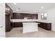 Modern kitchen with island, dark cabinetry, and white quartz countertops at 18428 W Poston Dr, Surprise, AZ 85387