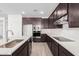 Modern kitchen with stainless steel appliances and dark cabinetry at 18428 W Poston Dr, Surprise, AZ 85387