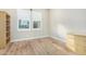 Bright bedroom featuring wood floors, white trim, and plantation shutters allowing natural light in the space at 11301 N Northfield St, Surprise, AZ 85388