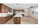 Modern kitchen with stainless steel appliances, island with sink, and wood cabinets at 11301 N Northfield St, Surprise, AZ 85388