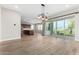 Open-concept living room featuring a decorative light fixture, and a sliding glass door to the backyard at 11301 N Northfield St, Surprise, AZ 85388