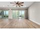 Spacious living room showcasing wood floors, a modern ceiling fan, and sliding glass doors at 11301 N Northfield St, Surprise, AZ 85388