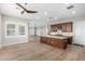 Modern living room featuring hardwood floors, open layout, with an adjacent kitchen and dining area at 11301 N Northfield St, Surprise, AZ 85388