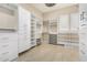 Spacious walk-in closet with custom shelving, drawers, and ample storage space for an organized wardrobe at 11301 N Northfield St, Surprise, AZ 85388