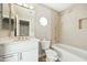 Updated bathroom with white vanity, bathtub, and shower at 14535 W Zuni Trl, Surprise, AZ 85374