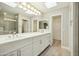 Bathroom boasts a double vanity, white cabinets, and a walk in shower at 14535 W Zuni Trl, Surprise, AZ 85374