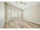 Bright bedroom featuring wood-look tile flooring and a bay window with shutters at 14535 W Zuni Trl, Surprise, AZ 85374