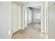 Hallway with white cabinets and wood-look tile floor at 14535 W Zuni Trl, Surprise, AZ 85374