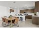 Open dining area and kitchen includes stainless steel appliances and ample counter space at 36378 W San Alvarez Ave, Maricopa, AZ 85138