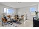 Bright living room features a large sectional sofa, modern decor, and plenty of natural light at 36378 W San Alvarez Ave, Maricopa, AZ 85138