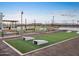 Community cornhole area with benches and artificial turf at 37264 W Patterson St, Maricopa, AZ 85138