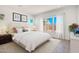 A serene bedroom with a queen bed, soft white bedding, a neutral color palette, and natural light at 16994 W Canterbury Dr, Surprise, AZ 85388