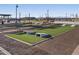 Outdoor lawn games area with cornhole and benches at 37375 W Patterson St, Maricopa, AZ 85138