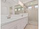 Bright bathroom featuring double sink vanity, and glass enclosed shower at 11942 W Parkway Ln, Avondale, AZ 85323