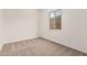 Bedroom featuring neutral carpet, white walls, and natural lighting at 11942 W Parkway Ln, Avondale, AZ 85323