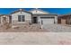 Charming single-story home with stone accents, neutral paint, paver driveway, and low maintenance desert landscaping at 11942 W Parkway Ln, Avondale, AZ 85323