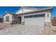 Charming home featuring a stone accents, gravel landscaping, and a two-car garage at 11942 W Parkway Ln, Avondale, AZ 85323