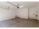 This garage is well lit with concrete floors, and a utility closet at 11942 W Parkway Ln, Avondale, AZ 85323
