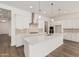 Bright kitchen featuring white cabinets, stainless steel appliances, a center island, and modern pendant lighting at 11942 W Parkway Ln, Avondale, AZ 85323