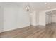 Open, airy living room with modern lighting, luxury vinyl plank flooring, and neutral paint at 11942 W Parkway Ln, Avondale, AZ 85323