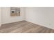 Empty room with wood floors, a single window, and neutral walls at 11942 W Parkway Ln, Avondale, AZ 85323