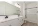 Bright bathroom featuring double sink vanity, large mirror, and modern fixtures at 11934 W Parkway Ln, Avondale, AZ 85323