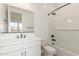 Bathroom featuring a sleek vanity, toilet, and a tiled shower-tub combo with modern fixtures at 11934 W Parkway Ln, Avondale, AZ 85323