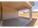 View of the covered patio with concrete floors and backyard at 11934 W Parkway Ln, Avondale, AZ 85323