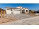 Exterior view of a single-Gathering home showcasing a three car garage at 11934 W Parkway Ln, Avondale, AZ 85323