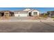 Charming single-story home featuring a two-car garage, desert landscaping, and neutral color palette at 11934 W Parkway Ln, Avondale, AZ 85323