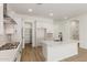 Stylish kitchen featuring a large island, white cabinetry, stainless steel appliances, and plenty of counter space at 11934 W Parkway Ln, Avondale, AZ 85323