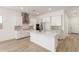 Bright kitchen with a large island, white cabinets, stainless steel appliances, and modern finishes at 11934 W Parkway Ln, Avondale, AZ 85323